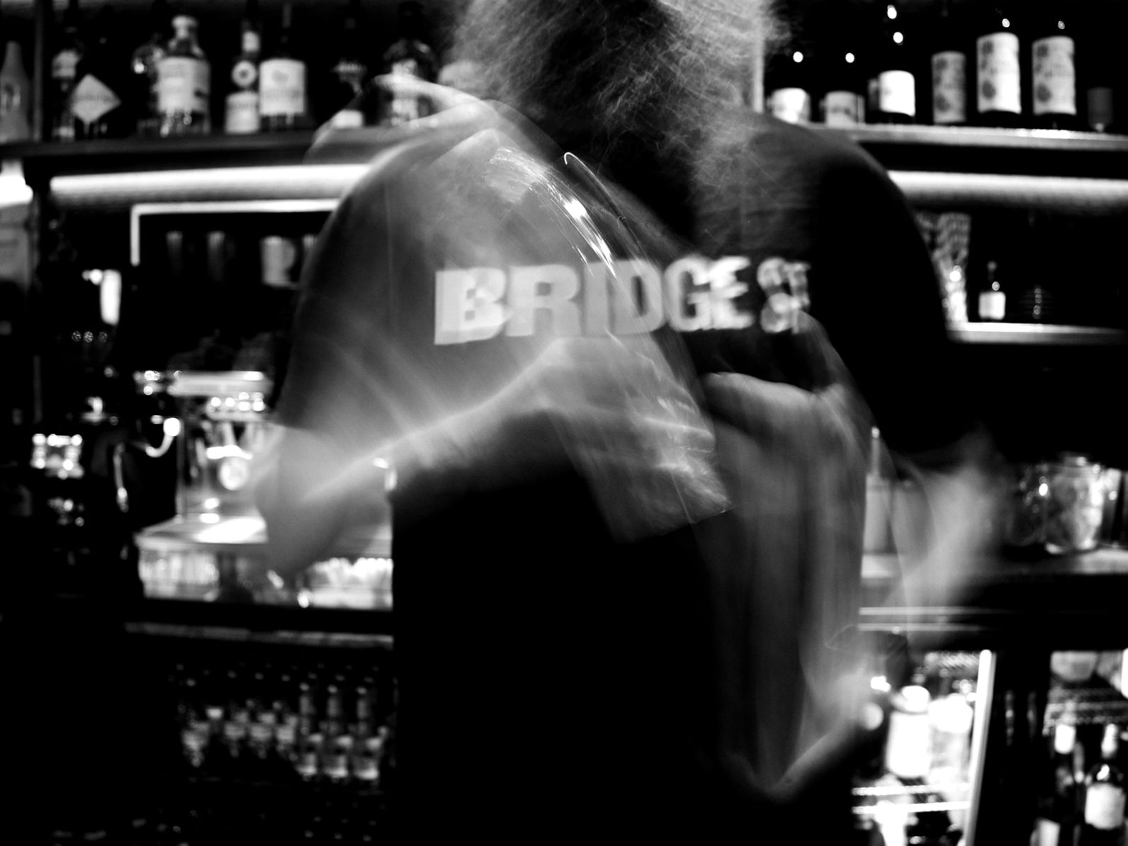A cocktail being shaken behind the bar